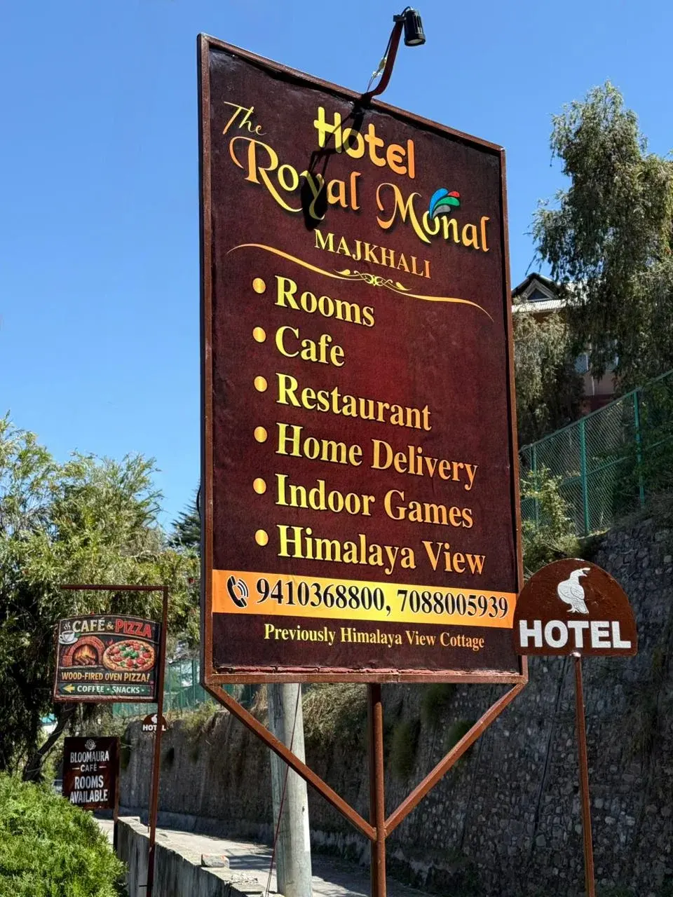 Hotel Royal Monal signboard listing amenities and services