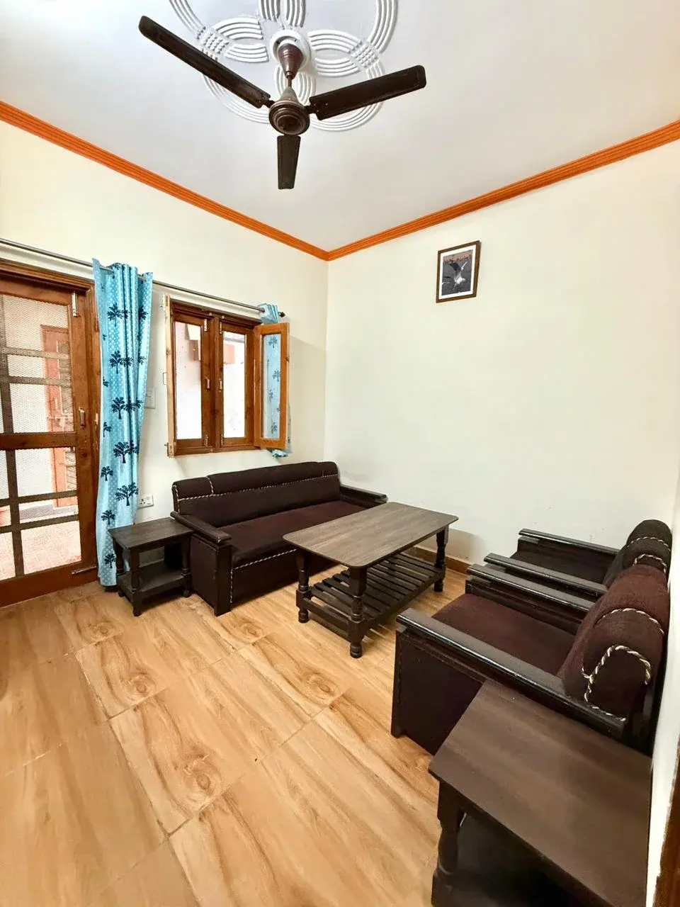 Inviting sitting room featuring faux wooden floors and warm lighting