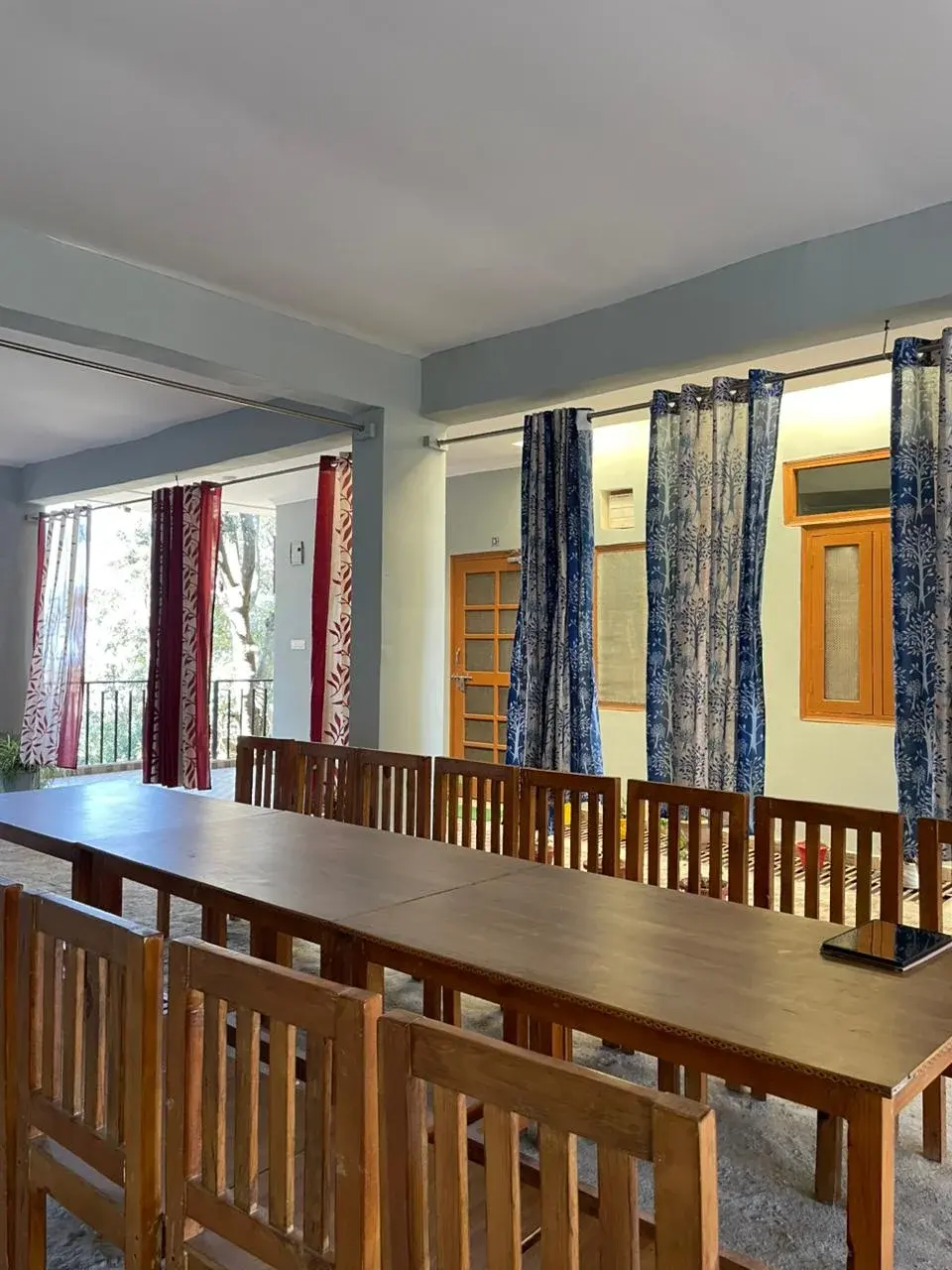 Spacious indoor dining hall equipped with long wooden tables for large groups