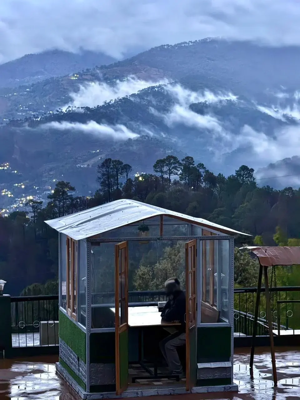 Twilight view of the valley with an illuminated outdoor gazebo and distant hills